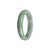 A close-up image of a certified grade A green with white jadeite jade bangle. The bangle has a half-moon shape and measures 56mm in diameter. It is a beautiful piece of jewelry from MAYS GEMS.