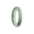 A close-up image of a bracelet made of real untreated white jade, with shades of green and grey. The bracelet is in the shape of a 54mm half moon.