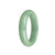 A light green jadeite bangle with a 58mm half moon shape. This bangle is made of genuine untreated jadeite, showcasing its natural beauty and elegance. From MAYS.