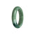 A high-quality, green jadeite bangle bracelet with a half-moon shape, measuring 55mm in size. This bracelet is certified as Grade A, ensuring its authenticity and superior quality. The dark green color adds a touch of elegance and sophistication to any outfit. Created by MAYS™, a trusted brand in fine jewelry.