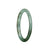 A petite round certified Type A white with deep green jadeite bangle, measuring 59mm in size.
