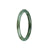 An elegant and petite round jade bangle bracelet in light green with deep green hues. It is untreated and authentic, adding a touch of natural beauty to your wrist.