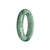 A beautiful green jade bangle bracelet with pale green and dark green patterns, made from genuine Grade A jadeite. The bracelet has a 56mm half moon shape and is designed by MAYS™.