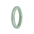 A beautiful light green and white jadeite bangle with a semi-round shape, measuring 58mm. Perfect for adding a touch of elegance to any outfit.