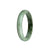 A half-moon shaped traditional jade bracelet made of real natural grey jade with hints of olive green.