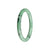 A close-up image of a delicate light green jade bracelet with a patterned design. The bracelet is round and petite, measuring 59mm in size. The jade stone is genuine and of Type A quality. This bracelet is a product of MAYS™.