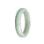 A beautiful bangle bracelet made of genuine natural white and pale green Burmese jade, featuring a 59mm half moon design. Perfect for adding an elegant touch to any outfit.