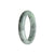 A close-up photo of a half-moon shaped grey green pattern jadeite jade bracelet, certified as Type A. The bracelet is 58mm in size and has a smooth and polished surface. It is a beautiful piece of jewelry from the MAYS™ collection.