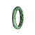 A close-up image of a beautiful green jade bracelet with a half moon shape. The bracelet is made of genuine natural jadeite jade and has a unique green pattern. It is 59mm in size and is sold by MAYS.