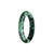 A beautiful half moon shaped Burmese Jade bracelet with a unique green and black pattern.