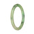 A close-up image of a delicate, light green jadeite bangle bracelet with a unique pattern. The bracelet is petite and round, measuring 55mm in diameter. This authentic piece of jadeite is untreated, showcasing its natural beauty. Created by MAYS GEMS.