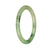 A close-up photo of a small round jadeite jade bangle with a natural light green pattern. The bangle is certified and is being sold by MAYS GEMS.
