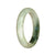 A half-moon shaped pale green and green traditional jade bracelet, measuring 52mm.