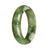 A half-moon shaped jadeite bangle bracelet with a genuine natural green pattern.