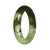 A beautiful traditional jade bangle with a deep green and light green pattern, featuring a half moon shape.