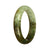 A close-up image of a traditional jade bangle with a green and white pattern. The bangle is 56mm in size and has a half moon shape. It is a genuine Grade A jade piece from MAYS GEMS.