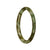 A close-up photo of a petite round olive green jade bangle bracelet with a natural and intricate pattern.