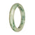 A beautiful Burmese jade bangle bracelet with a white and green pattern, featuring a 59mm half moon shape.