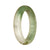 A beautiful green and white patterned Burmese jade bangle bracelet, certified Grade A. This bracelet features a 57mm half moon shape and is a luxurious addition to any jewelry collection. Designed by MAYS™.