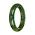 A close-up image of an authentic Type A deep green pattern traditional jade bangle bracelet with a half moon shape, measuring 57mm in diameter.