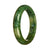 A stunning deep green jadeite jade bangle bracelet, featuring an authentic Type A half moon pattern.