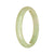 A light green jadeite bangle bracelet with a half moon shape, showcasing its authentic and untreated beauty.