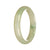 A half moon-shaped jade bangle with an untreated pale green pattern, showcasing its authentic beauty.
