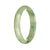A light green jade bracelet with a half moon pattern, measuring 56mm in size. Genuine Type A jade from MAYS GEMS.