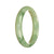 A light green jadeite jade bangle with a unique half moon pattern, untreated and genuine.