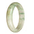 An image of a half moon-shaped jade bangle with a natural white color and a green pattern. This traditional bangle is authentic and exudes a sense of beauty and elegance. The bangle has a diameter of 62mm and is perfect for those seeking a unique and stylish accessory.