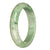 A close-up photo of an authentic Grade A light green pattern traditional jade bangle. The bangle has a half moon shape and measures 62mm in diameter. It is being sold by MAYS GEMS.