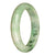 A close-up image of a light green jadeite jade bangle bracelet with a unique half moon pattern. This untreated, authentic piece is 62mm in size and is offered by MAYS™.