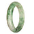 A close-up of a beautiful white and green patterned Burma Jade bangle with a half moon shape, showcasing its natural, untreated beauty.