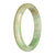 A close-up image of an untreated, authentic traditional jade bangle with a white and green pattern. The bangle is in the shape of a half moon and measures 79mm in diameter. It is a MAYS™ product.