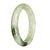 A traditional jade bangle bracelet with a half moon pattern in genuine natural white and green colors.