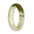 A close-up image of a beautiful jade bangle bracelet, featuring a combination of white and olive green hues. The bracelet has been certified as Grade A Burmese jade and has a unique half-moon shape with a diameter of 56mm. The brand name MAYS™ is also mentioned.