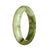 A half moon-shaped Burmese jade bangle with a certified natural white and green pattern.