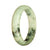 A stunning white and deep green patterned Burmese jade bangle, certified Grade A. This 58mm half moon-shaped bangle is truly exquisite.
