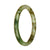 A petite round Burmese Jade bangle with a beautiful green, white, and brown pattern.