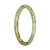 A petite round jadeite bangle bracelet in pale green and light brown with an authentic Grade A pattern.