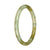 Close-up of a petite round Burmese jade bangle in pale green and light brown pattern, certified Grade A.