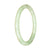 A delicate and elegant light green jadeite jade bracelet, featuring a petite round design measuring 60mm. Crafted with genuine Type A jade, this bracelet adds a touch of sophistication to any outfit.