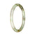 A small round pale green jade bangle with a natural untreated pattern, perfect for adding a touch of elegance to any outfit.