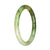 A light green and green patterned traditional jade bangle bracelet with a petite round shape, measuring 58mm.