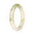 A half moon-shaped genuine untreated white jade bangle with a brown pattern, showcasing its traditional beauty.