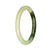 A small, round jade bangle with a beautiful white and green pattern. Perfect for adding a touch of elegance to any outfit.