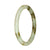 Close-up image of a petite round jade bangle bracelet in pale green and brown patterns.