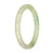 A petite round bangle made of certified natural light green and lavender jadeite, measuring 59mm in size. Perfect for adding a touch of elegance to any outfit.
