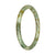 A close-up image of a small, round jade bangle bracelet with a unique pattern of green and brown colors. The bracelet is made from genuine natural jade and has a diameter of 61mm. It is a petite and elegant piece of jewelry designed by MAYS.