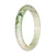 A pale green jadeite bracelet with a unique green pattern, offering a genuine Grade A quality. The bracelet is in the shape of a 67mm half moon, crafted by MAYS GEMS.